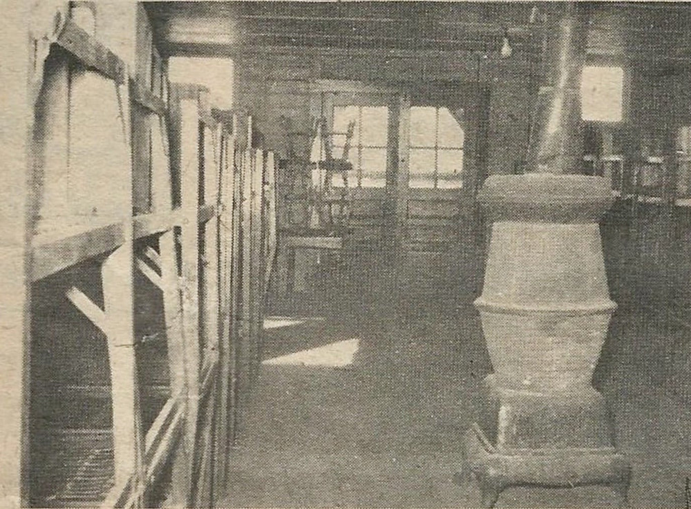 old dorms showing the pot belly stove and bunks